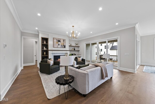 living room featuring a notable chandelier, crown molding, and dark hardwood / wood-style flooring