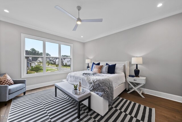 bedroom featuring ceiling fan, crown molding, and dark wood-type flooring