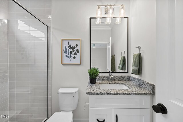 bathroom featuring vanity, toilet, and an enclosed shower