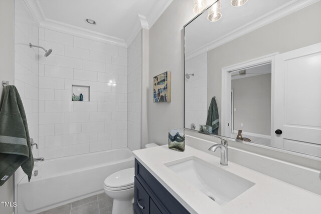 full bathroom featuring tiled shower / bath, vanity, crown molding, and toilet