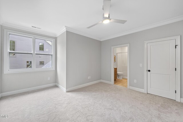 unfurnished bedroom featuring connected bathroom, ceiling fan, light colored carpet, and crown molding