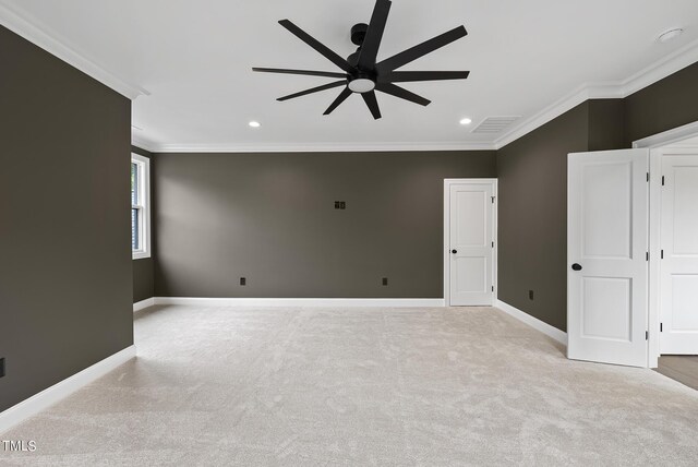 carpeted spare room featuring crown molding and ceiling fan