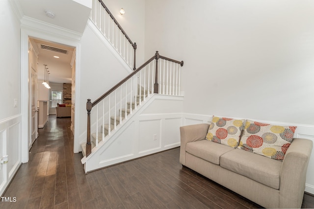 interior space with dark wood-type flooring and ornamental molding