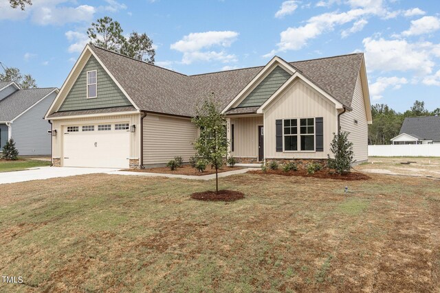 view of front of property with a garage and a front yard