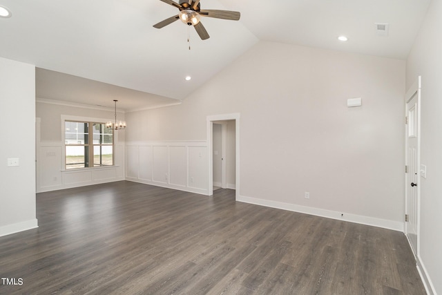 empty room featuring ceiling fan with notable chandelier, dark wood-style flooring, wainscoting, and recessed lighting