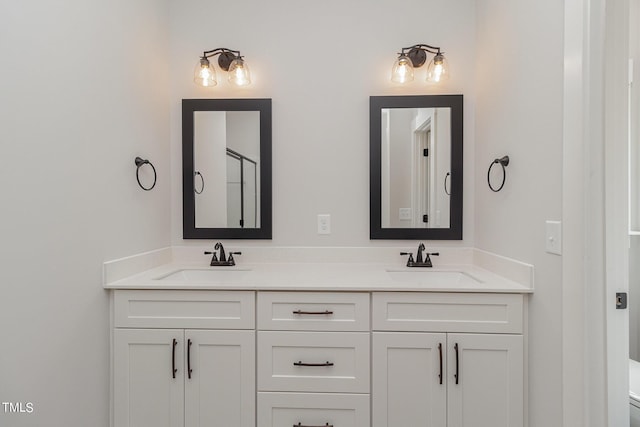 full bathroom with a sink, toilet, and double vanity