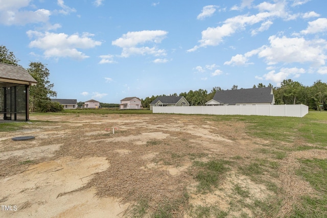 view of yard with a residential view and fence