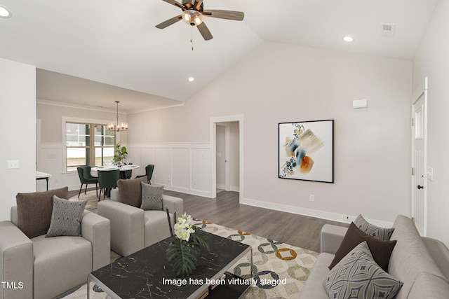 living area featuring recessed lighting, ceiling fan with notable chandelier, dark wood-type flooring, vaulted ceiling, and wainscoting