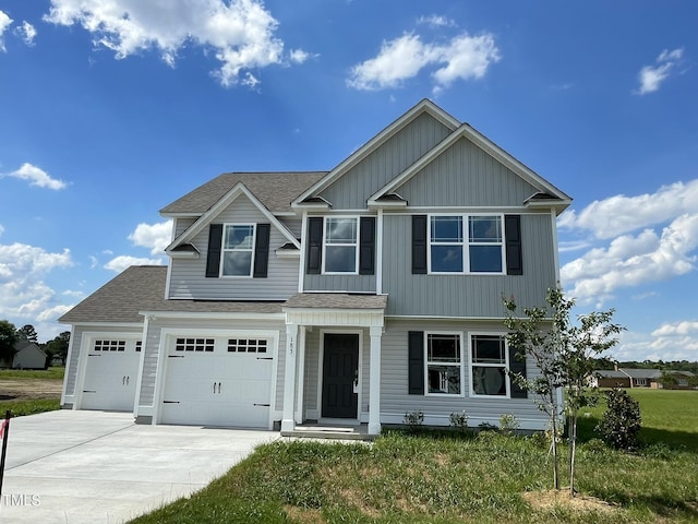 view of front of home featuring a garage and a front lawn