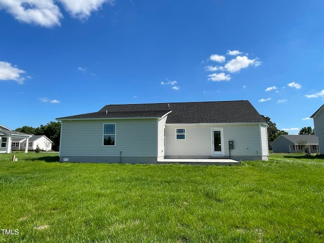 back of house featuring a patio and a lawn