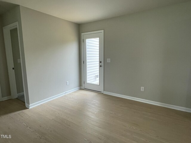 empty room with wood-type flooring