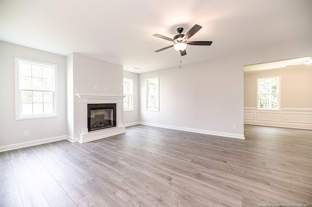 unfurnished living room with ceiling fan and hardwood / wood-style flooring