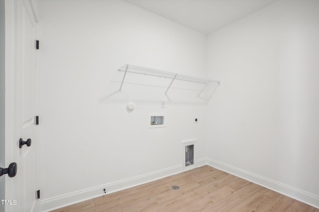 laundry room featuring light wood-type flooring, gas dryer hookup, hookup for an electric dryer, and washer hookup