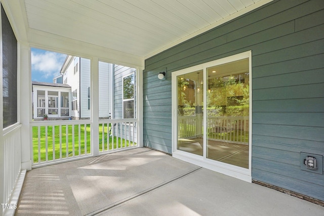 unfurnished sunroom featuring wooden ceiling