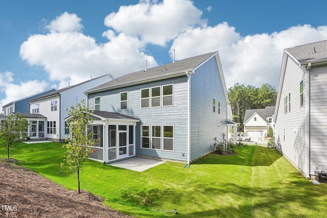 rear view of property featuring a sunroom and a yard