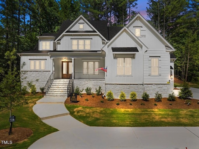 view of front facade with a porch and a yard