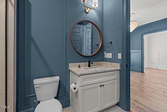 bathroom with vanity, hardwood / wood-style flooring, and toilet