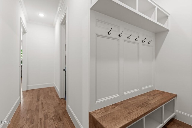 mudroom with hardwood / wood-style floors and crown molding