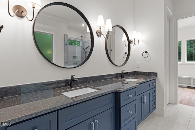 bathroom featuring vanity, tile patterned floors, walk in shower, and crown molding