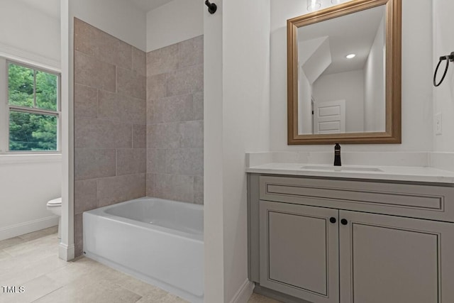 full bathroom featuring tile patterned floors, vanity, toilet, and tiled shower / bath