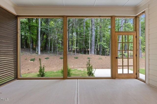 doorway to outside featuring ornamental molding