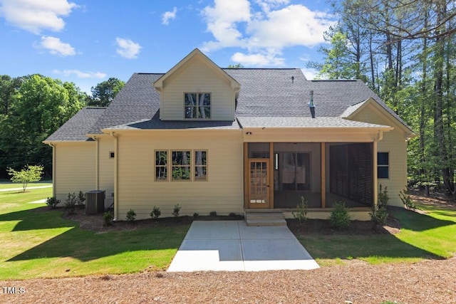 rear view of property with central AC, a yard, a patio, and a sunroom