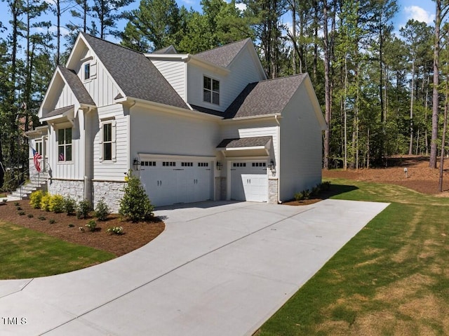 view of front of house with a garage and a front lawn