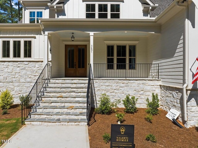 entrance to property featuring covered porch and french doors