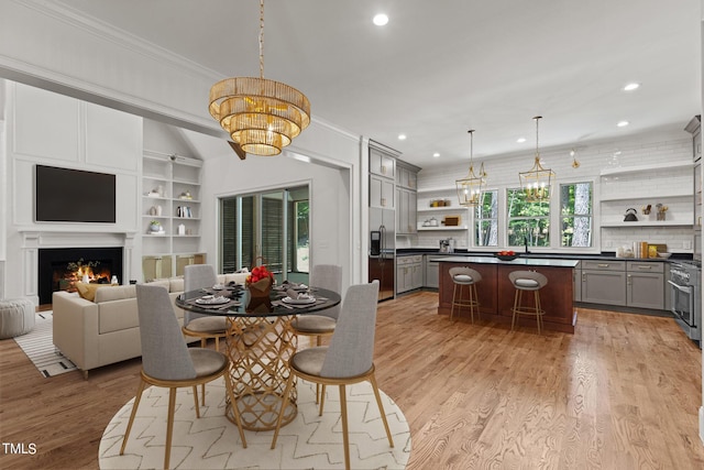 dining room featuring light hardwood / wood-style flooring and ornamental molding