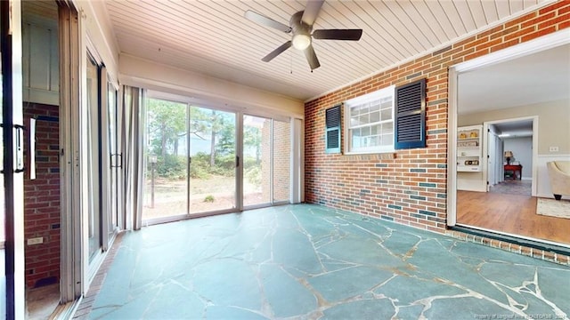 unfurnished sunroom featuring wooden ceiling and ceiling fan