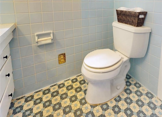 bathroom featuring tile walls, toilet, tile floors, and vanity