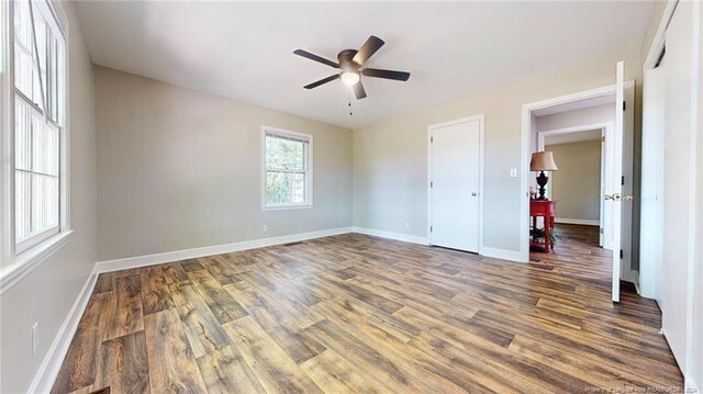 unfurnished bedroom featuring wood-type flooring and ceiling fan