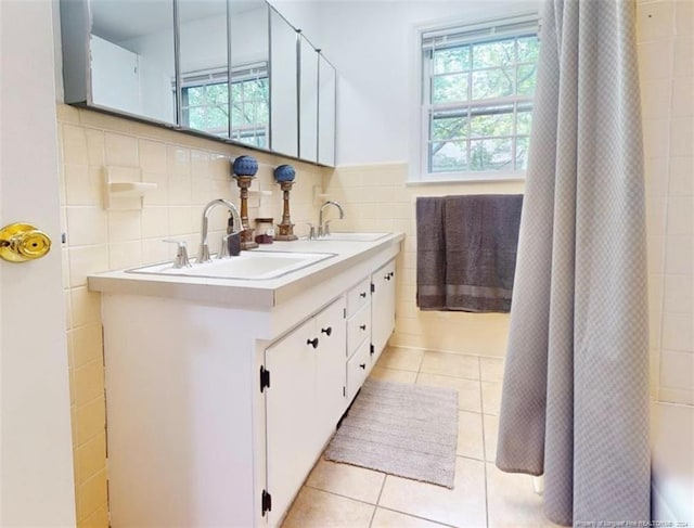 bathroom with tile flooring, tile walls, oversized vanity, tasteful backsplash, and double sink