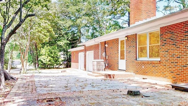 view of side of home featuring a patio