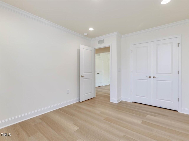 unfurnished bedroom with light wood-style floors, visible vents, and baseboards