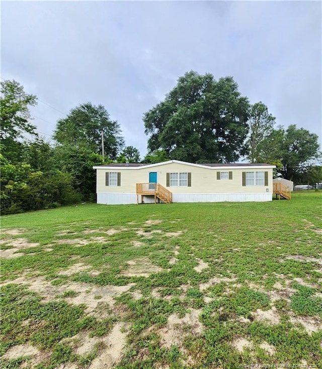 back of property featuring a yard and a wooden deck