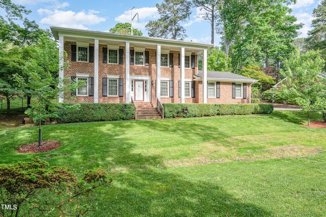 greek revival inspired property featuring a front yard