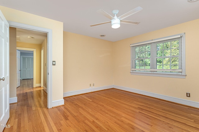 empty room with ceiling fan and light wood-type flooring