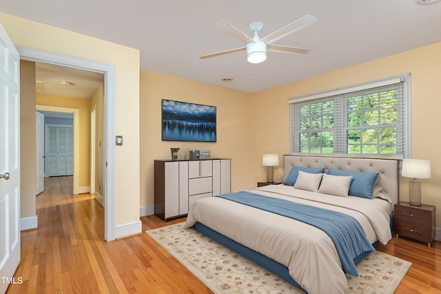 bedroom with light wood-type flooring and ceiling fan