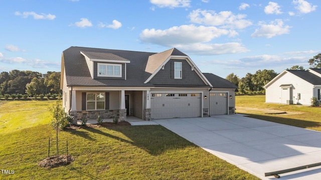 craftsman inspired home with a garage, a front yard, and covered porch