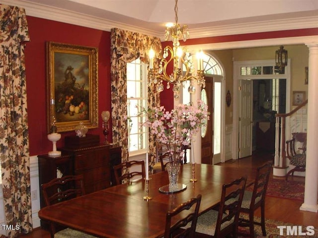 dining area featuring crown molding, ornate columns, dark hardwood / wood-style floors, and an inviting chandelier