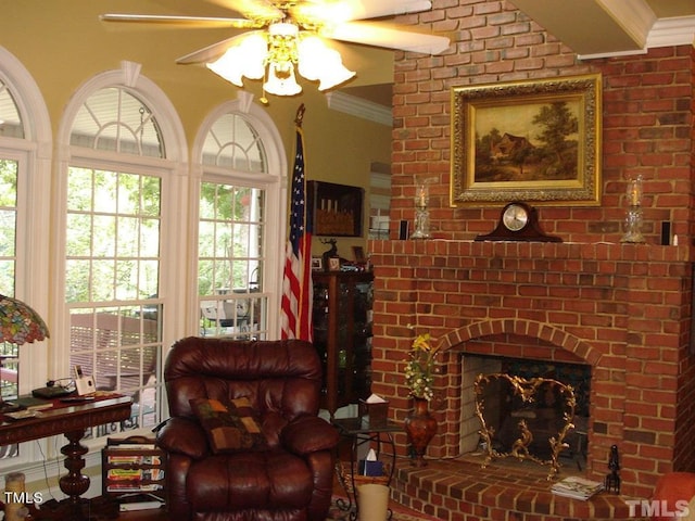 living room with ceiling fan, crown molding, a fireplace, and plenty of natural light