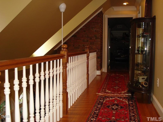 hallway featuring ornamental molding and dark wood-type flooring