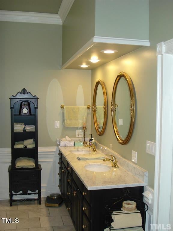 bathroom with tile floors, double vanity, and crown molding