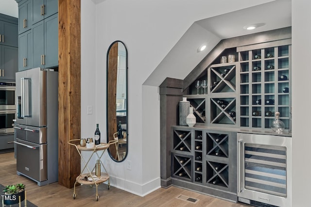 wine room featuring light wood-type flooring and beverage cooler