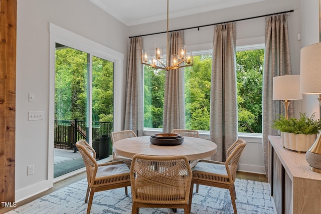 dining space with plenty of natural light, an inviting chandelier, and hardwood / wood-style floors