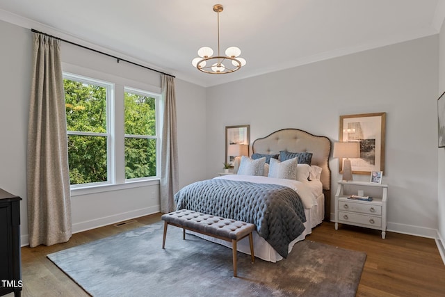 bedroom with dark hardwood / wood-style flooring, multiple windows, a chandelier, and crown molding