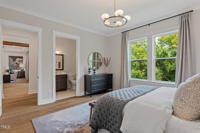 bedroom with a notable chandelier, light hardwood / wood-style floors, ensuite bathroom, and crown molding