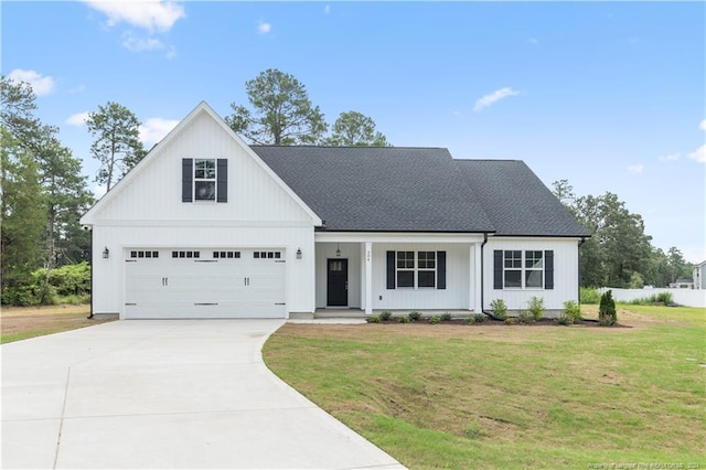 modern farmhouse featuring a front yard and covered porch