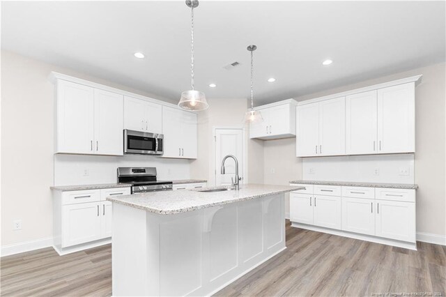 kitchen with light hardwood / wood-style flooring, sink, stainless steel appliances, and white cabinets